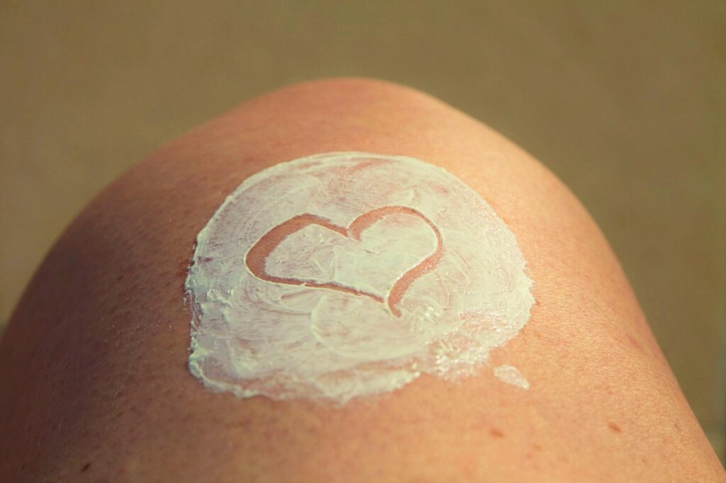 smeared sun-screen on skin in the shape of a heart as Natural Anti-Aging Habits