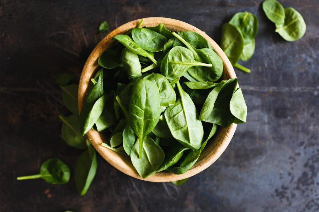 spinach in a wooden bowl
