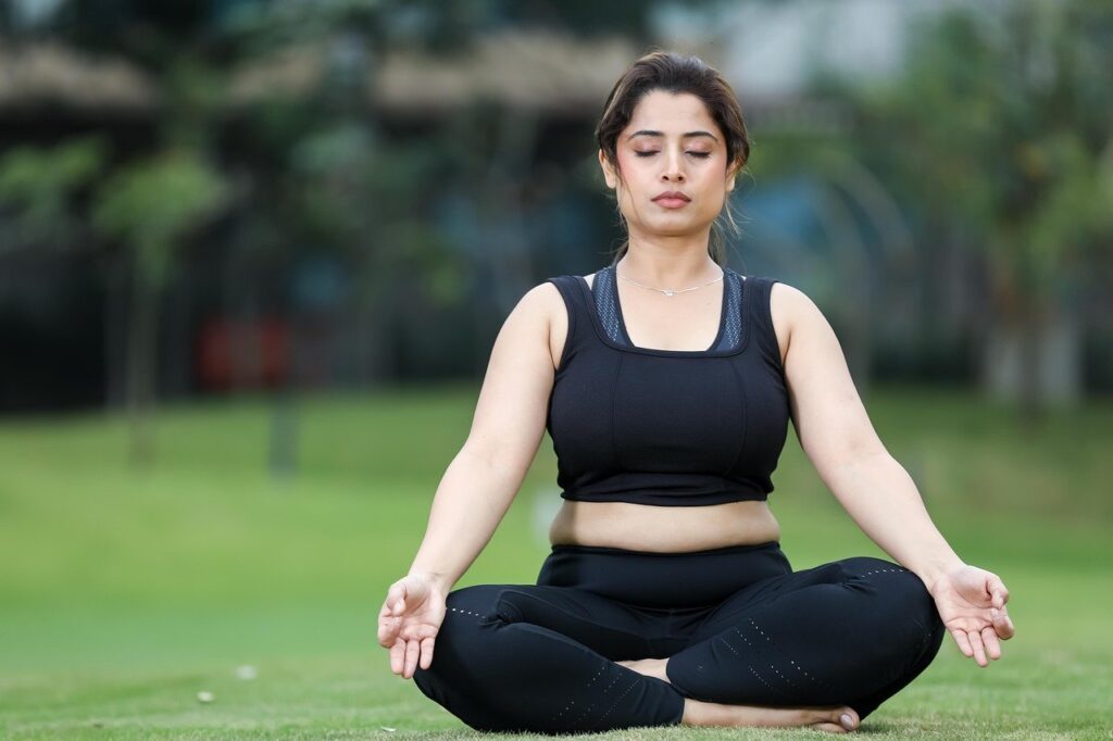 woman in black doing yoga
